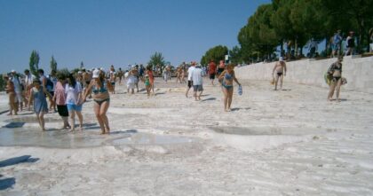 Wakacje Polaków 2026 – turyści na białych tarasach Pamukkale w Turcji